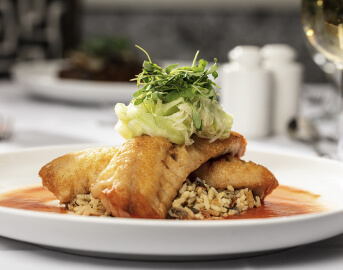 Grilled Salmon on Bed of Rice Topped with Greens Served at Senior Living Community Grilled Salmon on Bed of Rice Topped with Greens Served at Senior Living Community