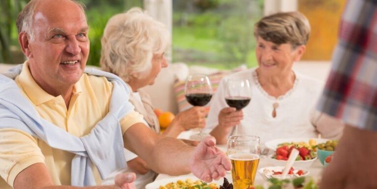 Elderly Group Enjoying Lunch and Drinks Together at an Assisted Living Facility